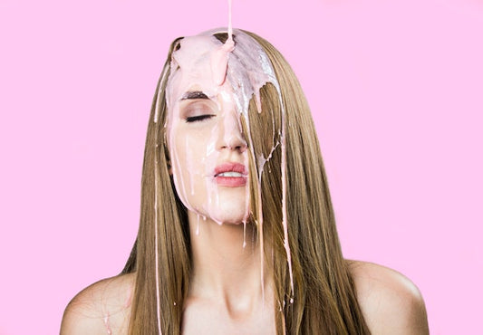 woman with liquid pouring on hair