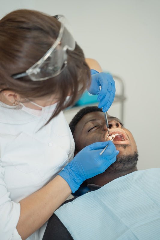 dentist treating male patient with gum disease